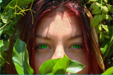 Portrait surrounded by green leaves