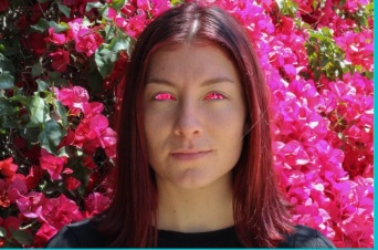 Portrait in front of pink flowers